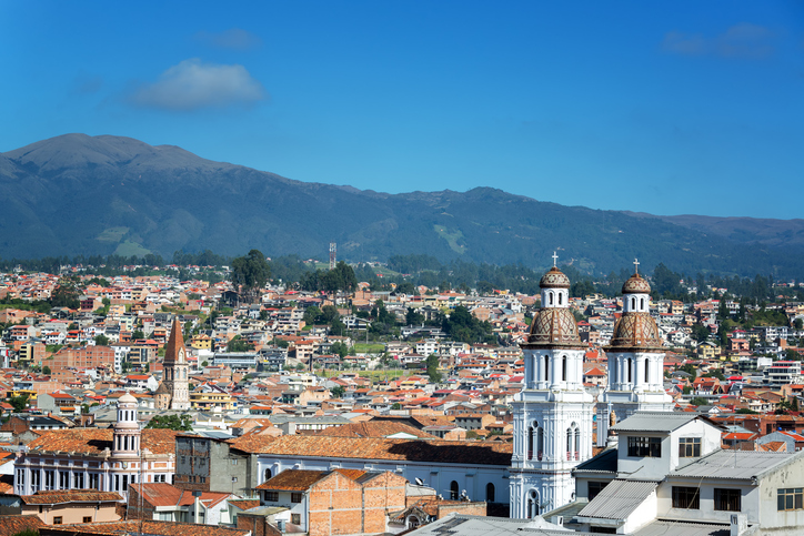 Cityscape of Cuenca, Ecuador with Santo Domingo church visible in the bottom right